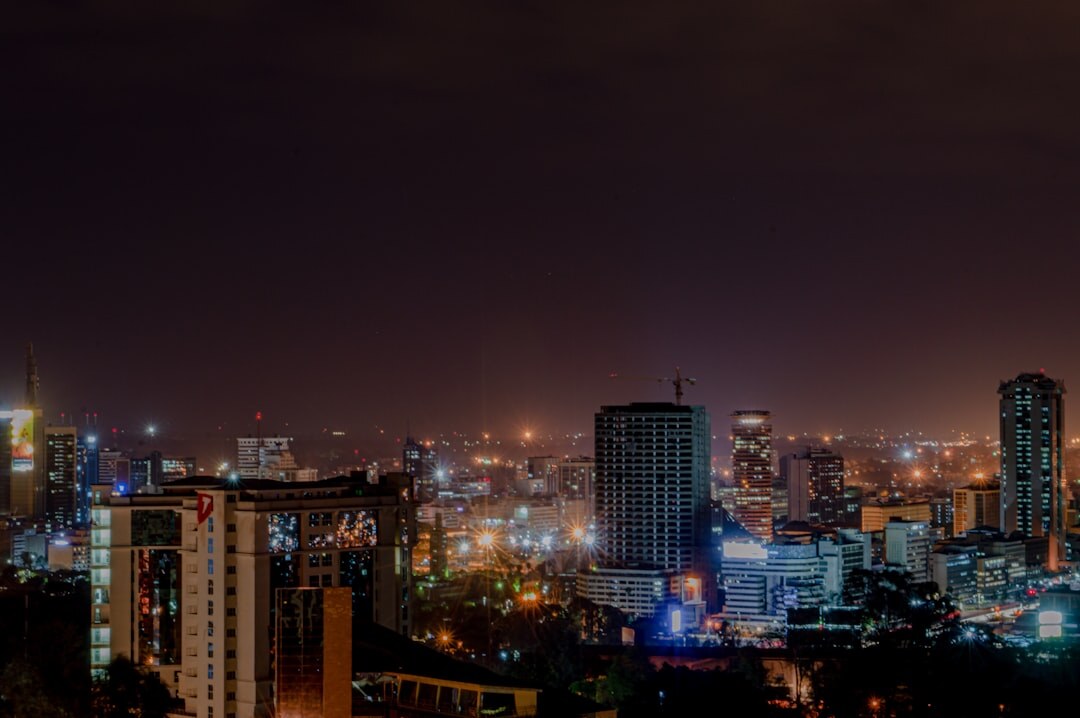 City skyline illuminated at dusk with warm lights