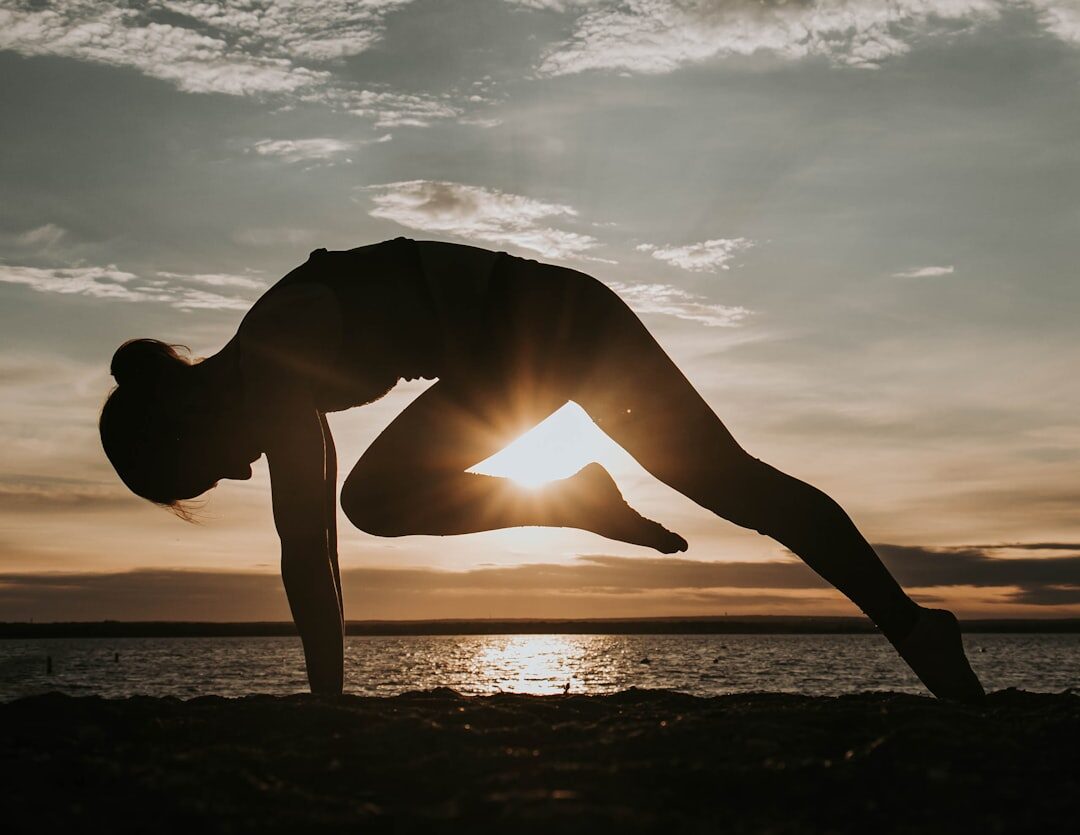woman practicing yoga at dawn