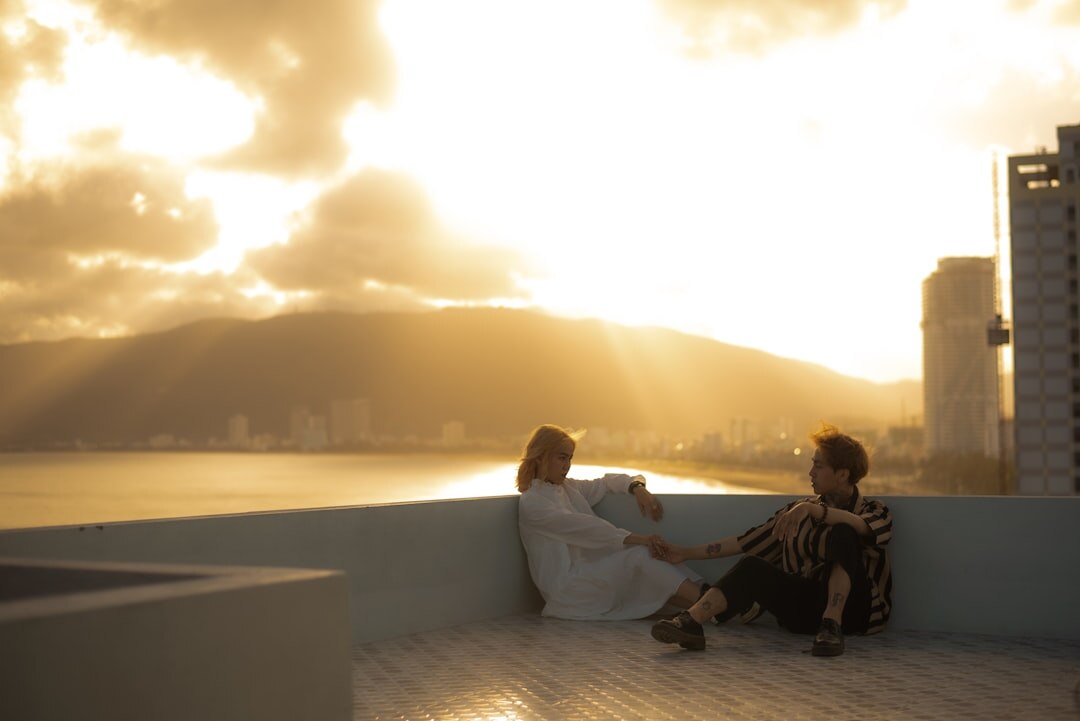 couple holding hands sunset