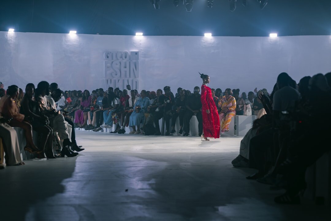 Fashion runway show with models walking under bright lights